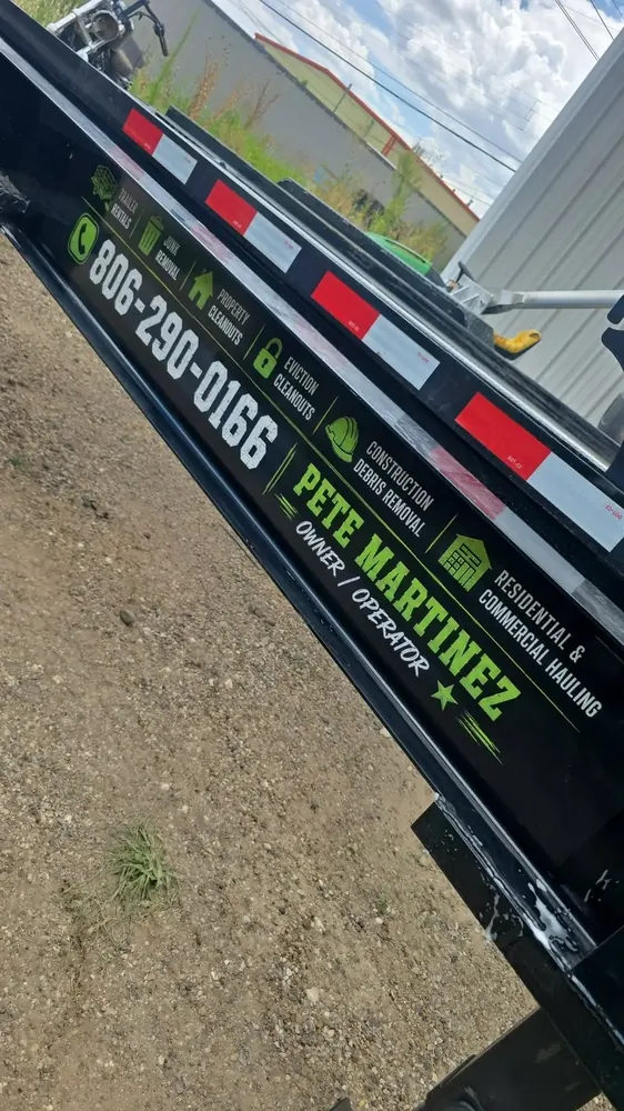 The Outlaw Haulin decal on the side of the trailer, showing the services and Pete Martinez, owner and operator
